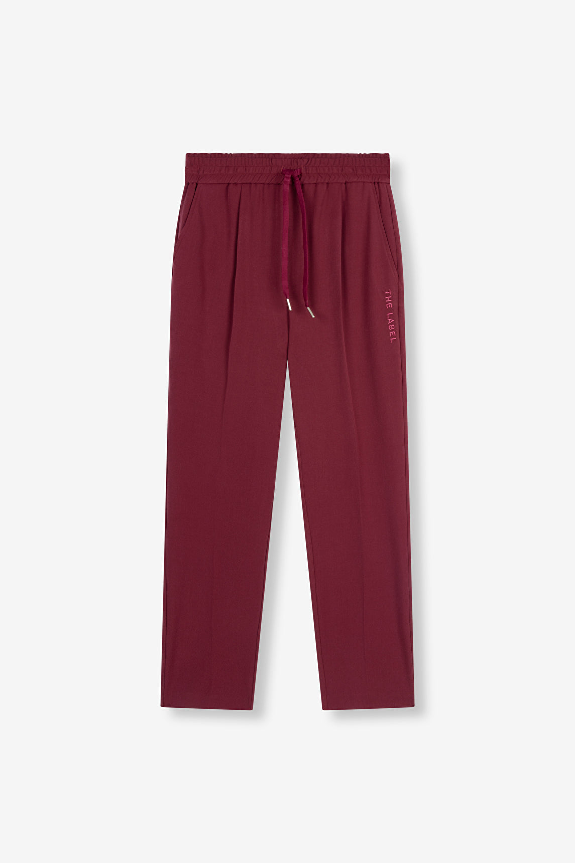 Melange pants bordeaux Alix The Label, coupe fluide avec taille élastique et broderie "THE LABEL" sur le côté.
